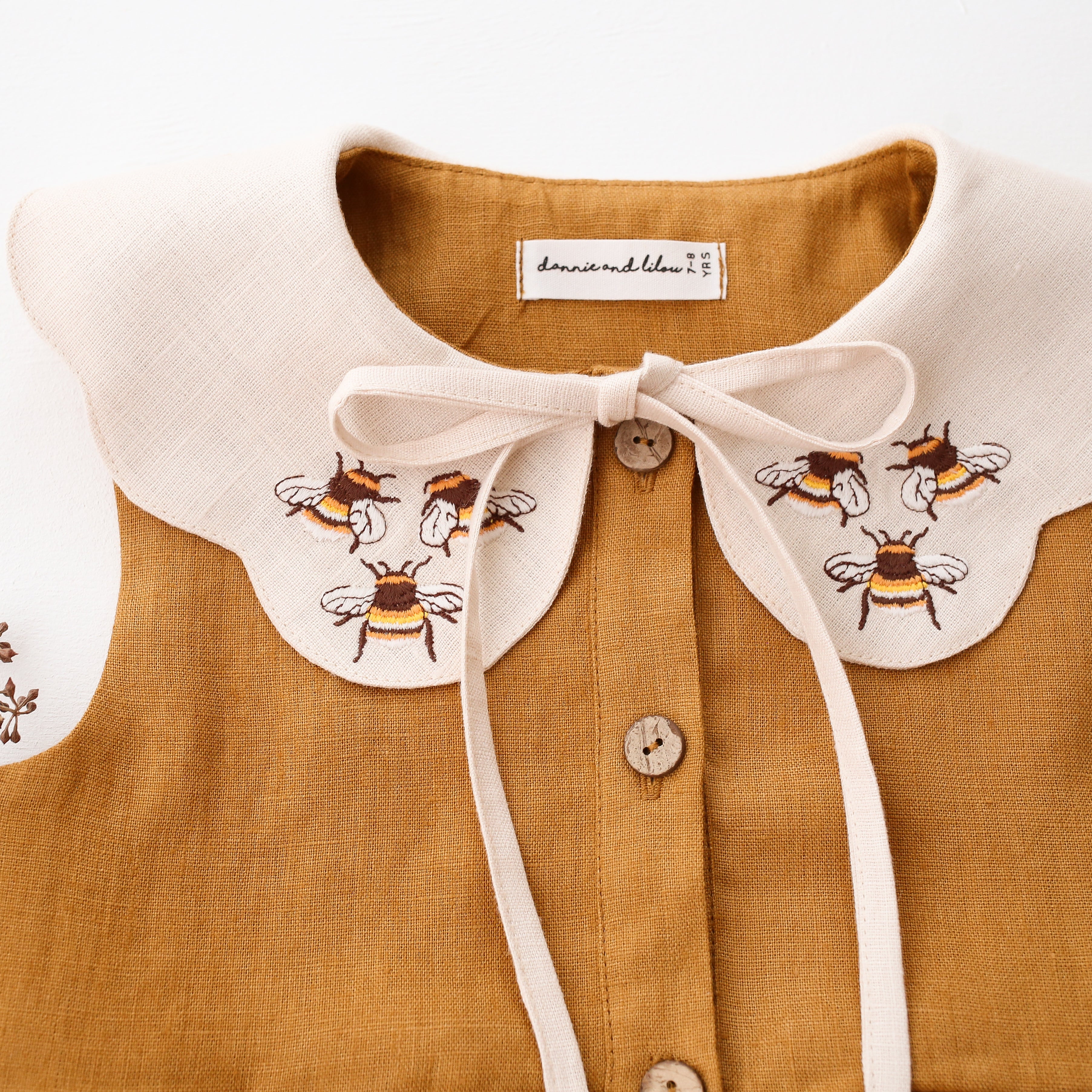 Mustard Linen Tiered Dress with Petal Collar in Ivory Linen with "3 Bumblebees" Embroidery