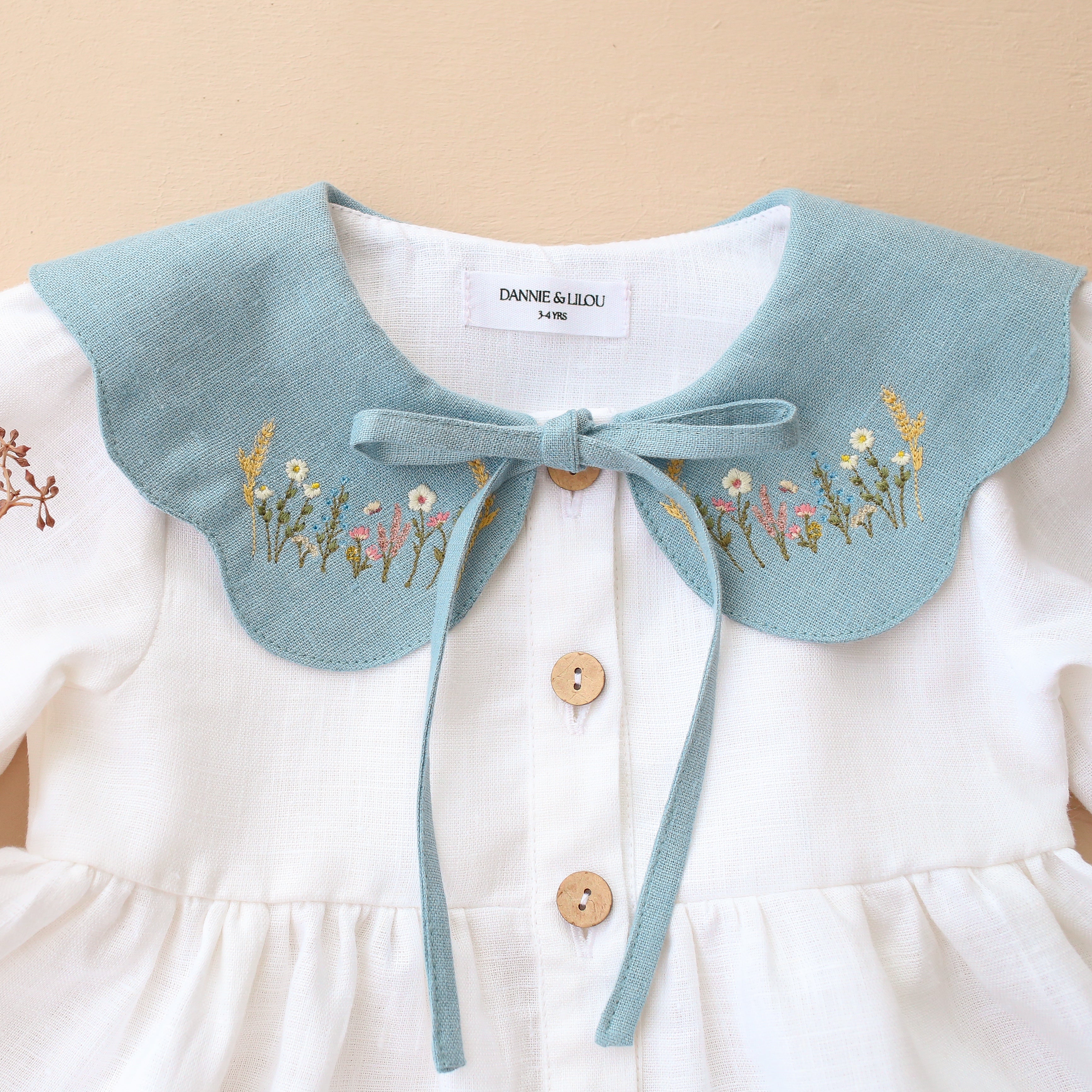 White Linen Long Sleeve Tiered Dress with Petal Collar in Chalky Blue Linen with "Wheat Flower Field" Embroidery