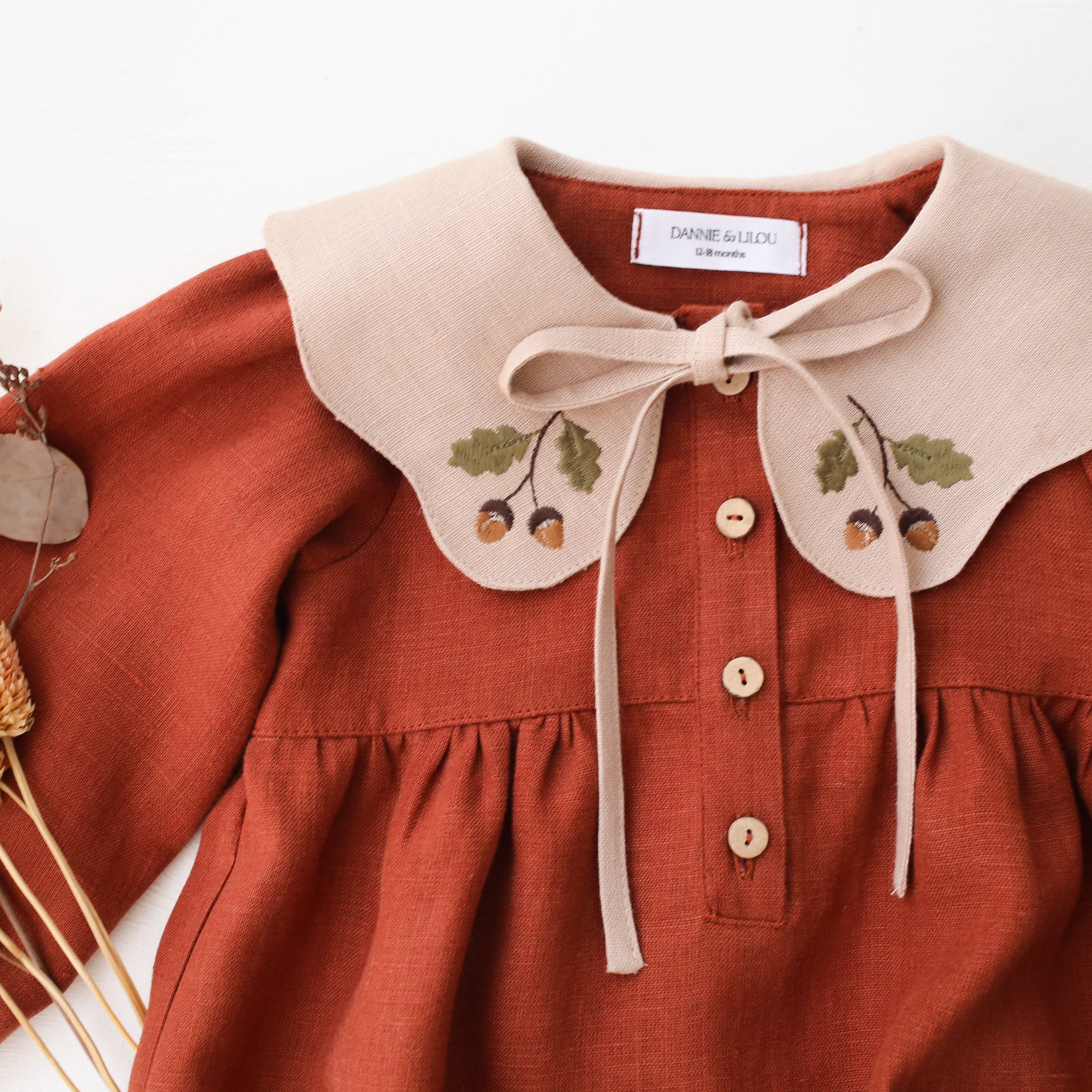 Rust Linen Long Sleeve Bubble Playsuit with Petal Collar in Beige Linen with “Mini Acorns” Embroidery