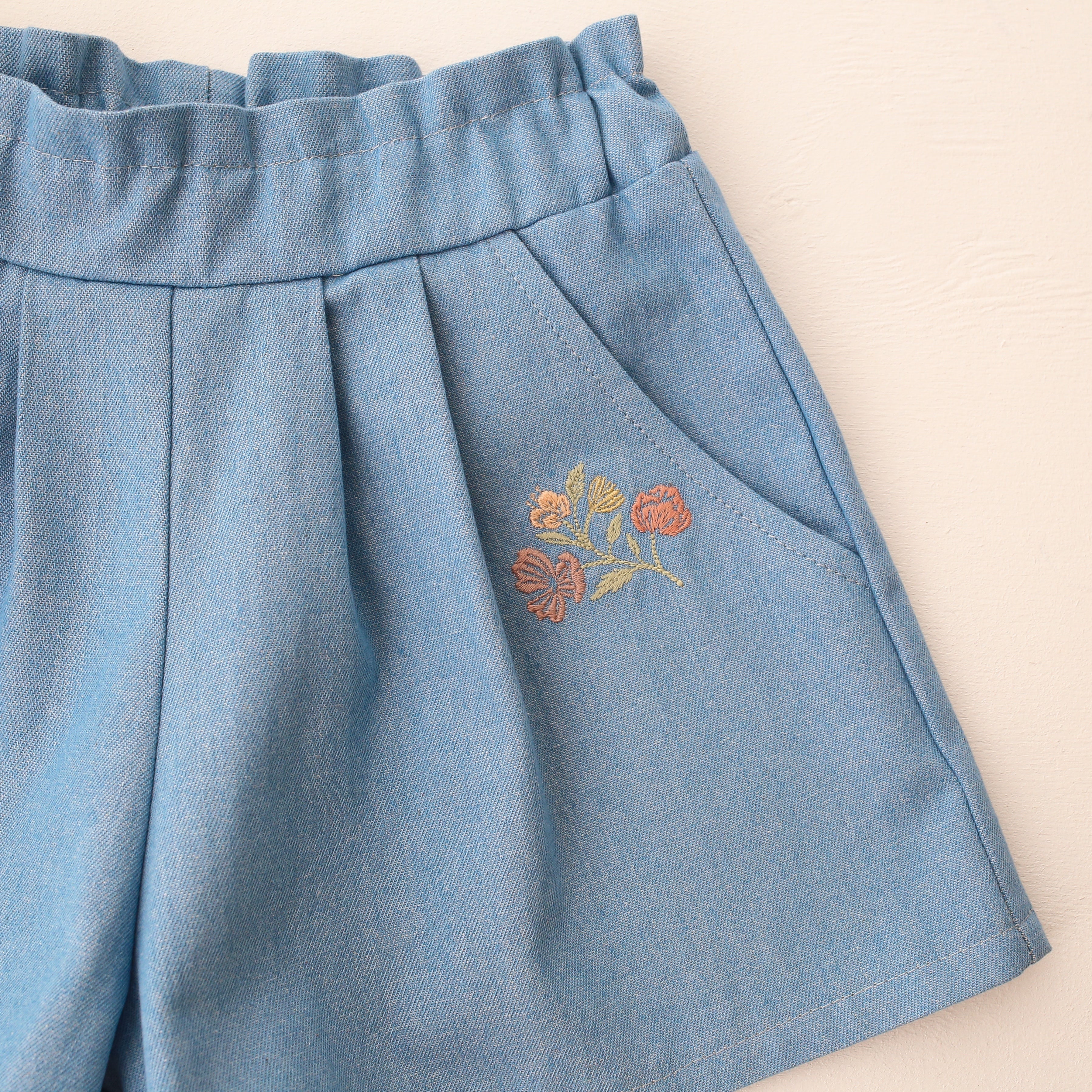 Light Denim Paperbag Waist Shorts with "Wild Bells" Embroidery