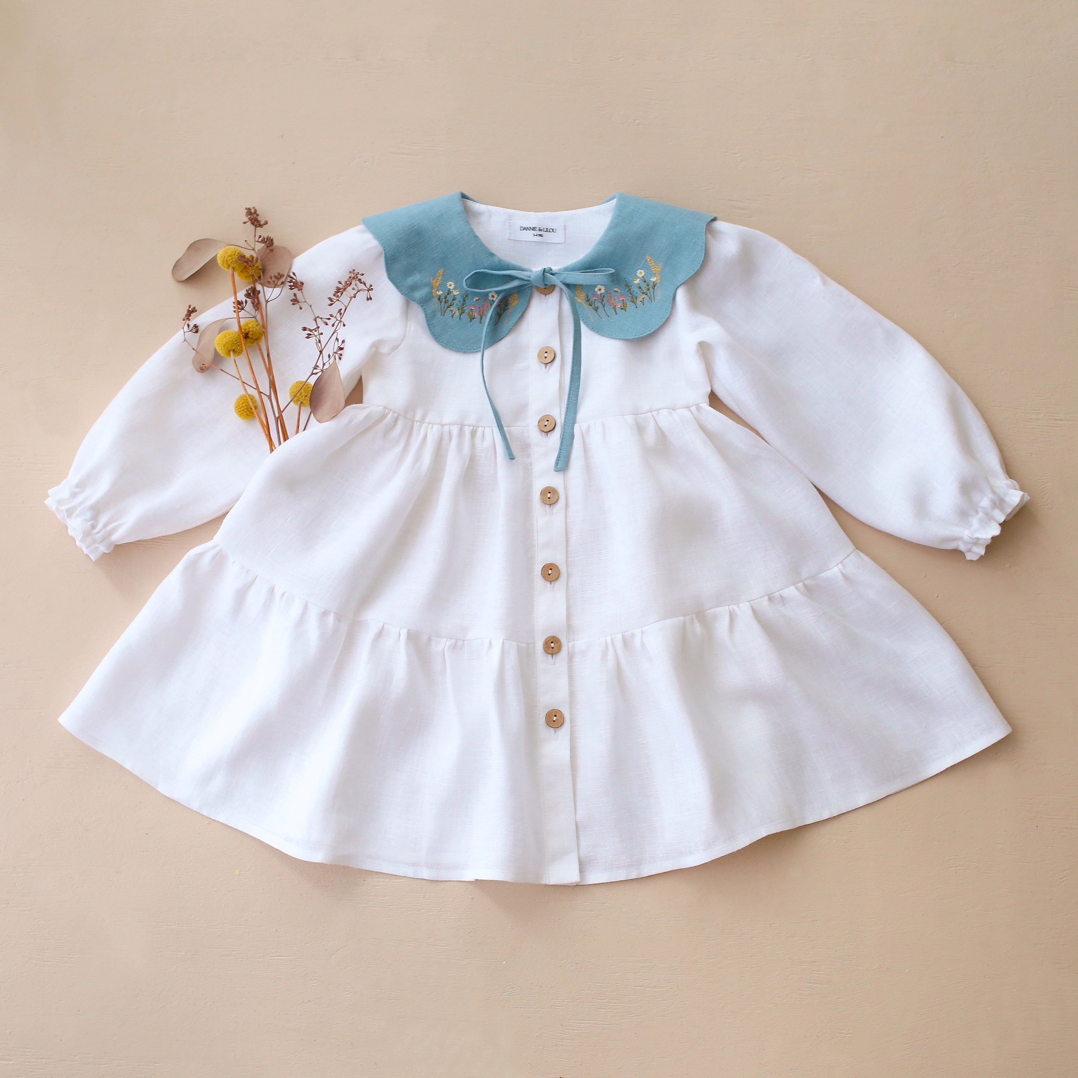 White Linen Long Sleeve Tiered Dress with Petal Collar in Chalky Blue Linen with "Wheat Flower Field" Embroidery