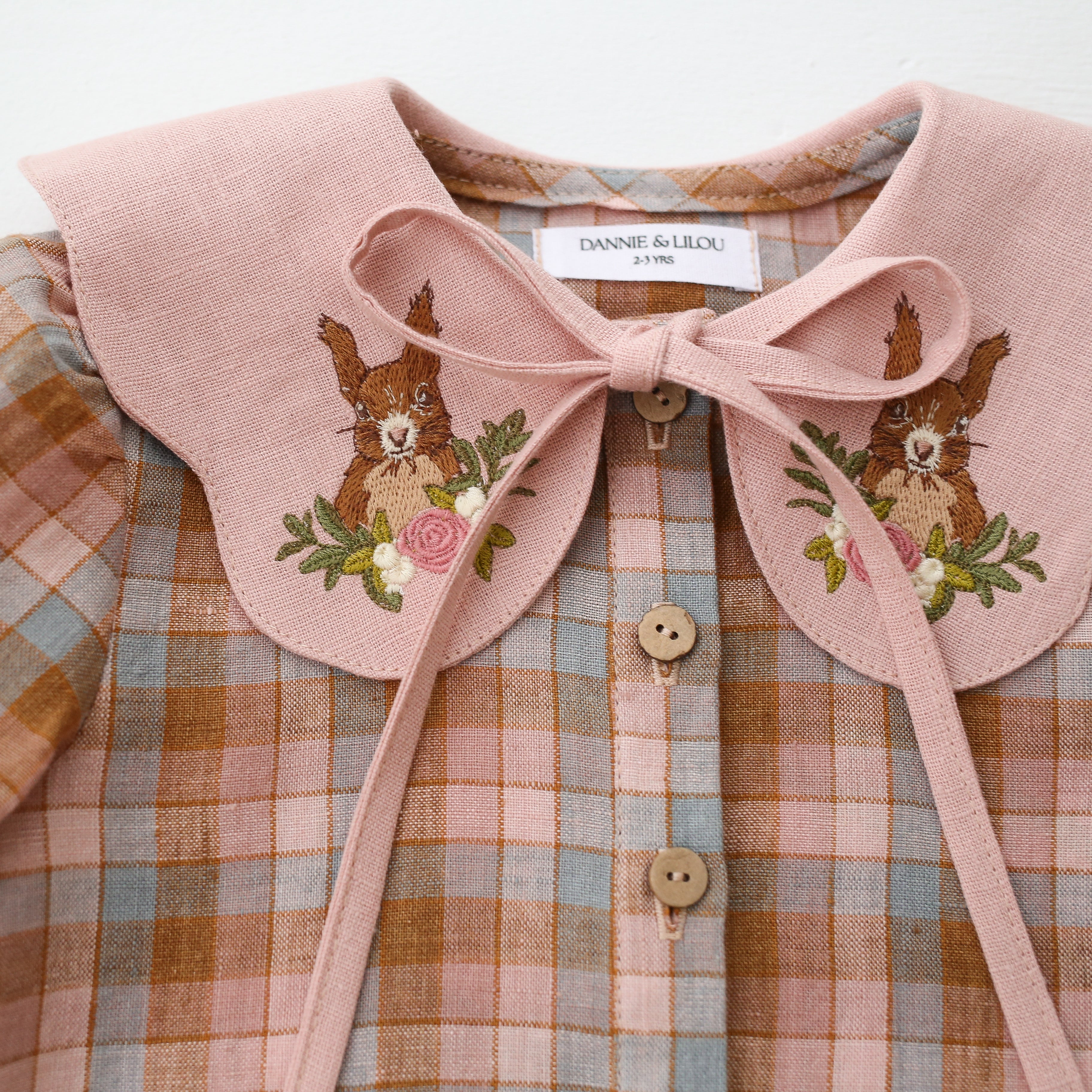 Hazel Rose Check Linen Long Sleeve Button Front Blouse with Petal Collar in Powder Linen with “Squirrel in Flowers” Embroidery