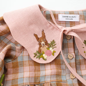 Hazel Rose Check Linen Long Sleeve Bubble Playsuit with Petal Collar in Powder Linen with "Squirrel in Flowers" Embroidery