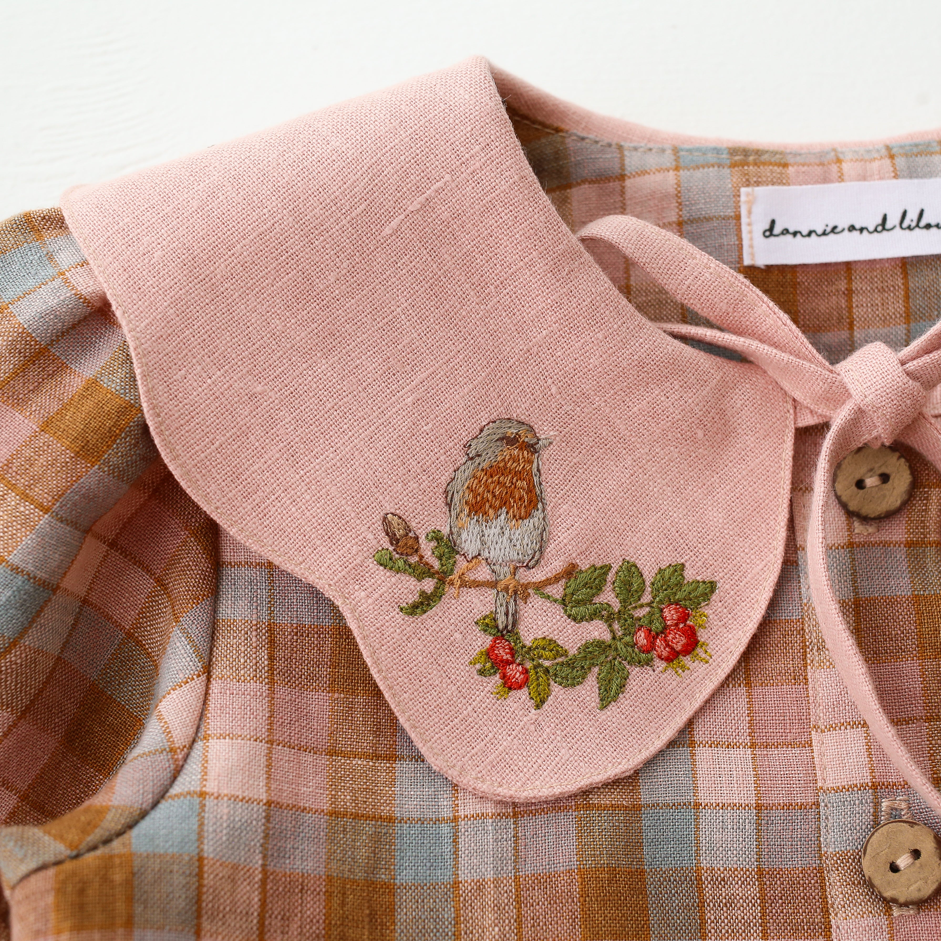 Hazel Rose Check Linen Long Sleeve Tiered Dress with Petal Collar in Powder Linen with "Bird on Berry Branch" Embroidery